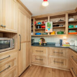 Pantry with light brown stained cabinets