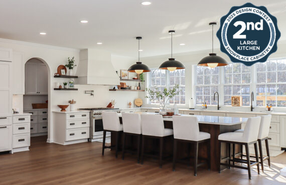 White perimeter kitchen cabinets with a dark stained island.