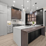 Light gray and black painted kitchen cabinets with walnut accent hutch cabinets, with a pullout walnut table connected to the island.