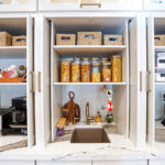 Open pocket doors showing appliances and items inside.