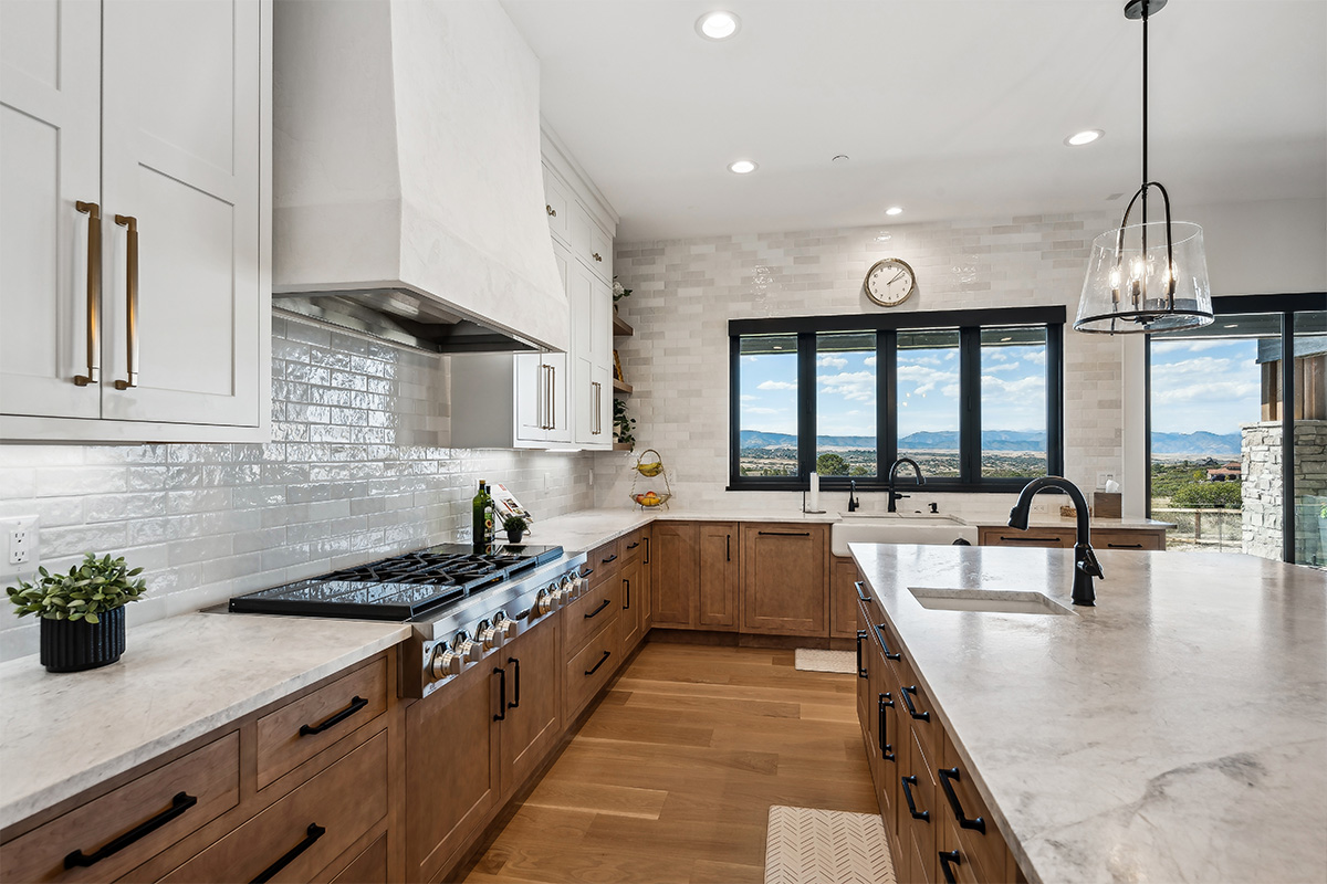 White painted and light brown stained kitchen with island.