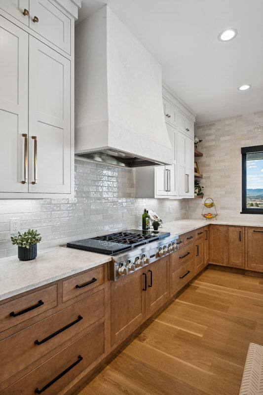 White painted and light brown stained kitchen with island.
