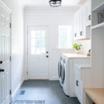 Painted white laundry/mud room with lockers.