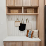 Light stained mudroom locker cabinets.