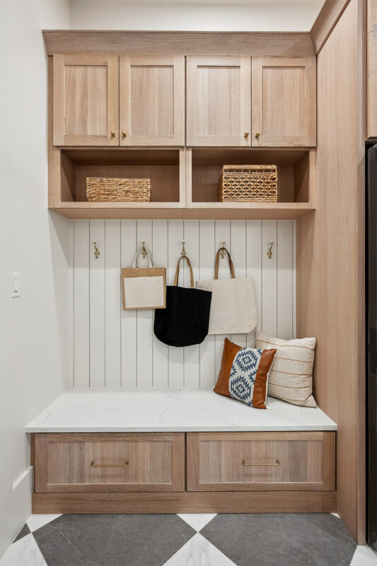 Light stained mudroom locker cabinets.