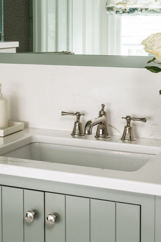 Light green painted bathroom vanity.