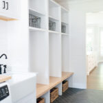 Painted white laundry/mud room with lockers.