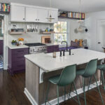 White and purple painted kitchen cabinets with stained hickory island cabinets.