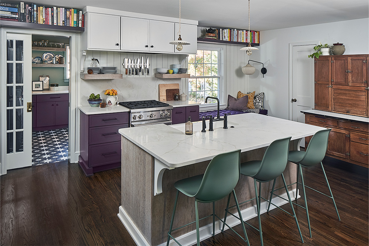 White and purple painted kitchen cabinets with stained hickory island cabinets.