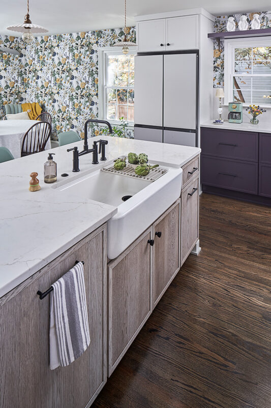 White and purple painted kitchen cabinets with stained hickory island cabinets.