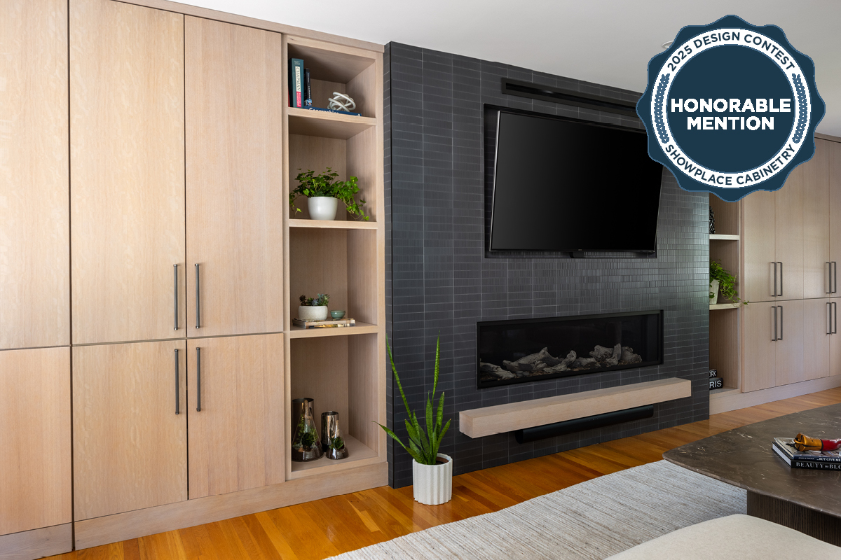 Dark brick fireplace with TV above and light stained cabinets on both sides.