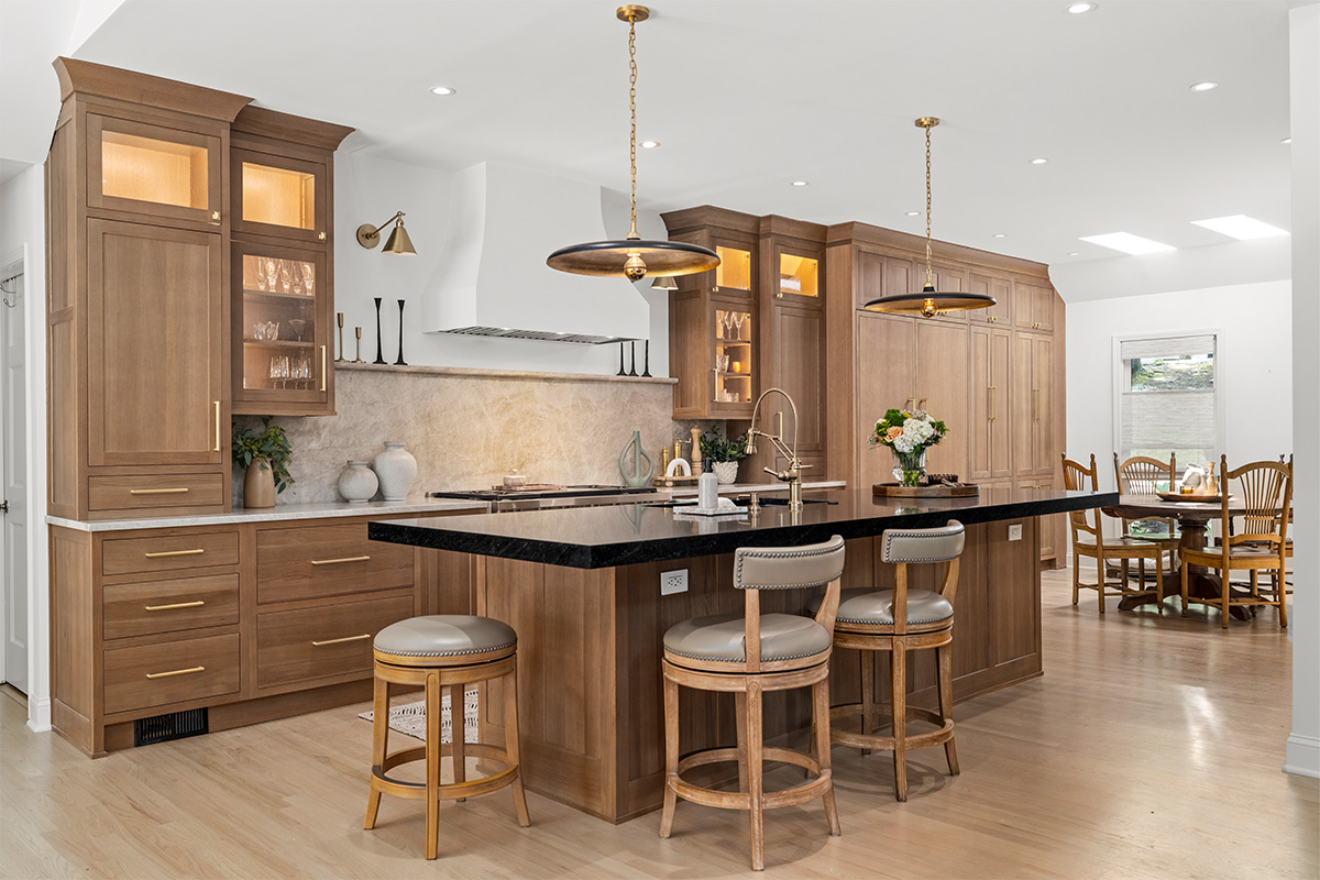 Stained white oak kitchen with a white hood.