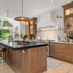 Stained white oak kitchen with a white hood.