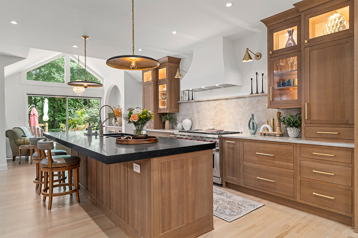 Stained white oak kitchen with a white hood.