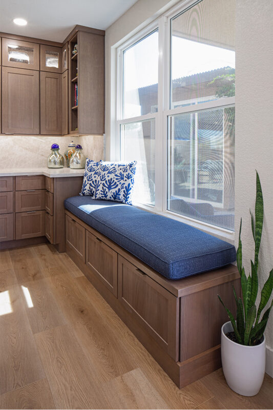 Brown-stained bench seating with blue cushion