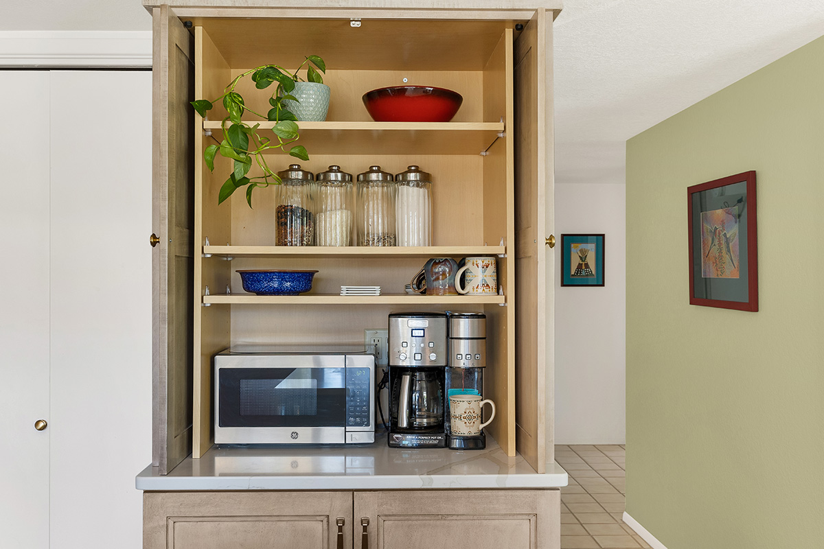Open pocket doors showing appliances behind the doors.