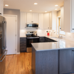 White uppers and gray stained lower kitchen cabinets