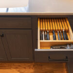 Base cabinet with drawer pulled out showing a knife organizer