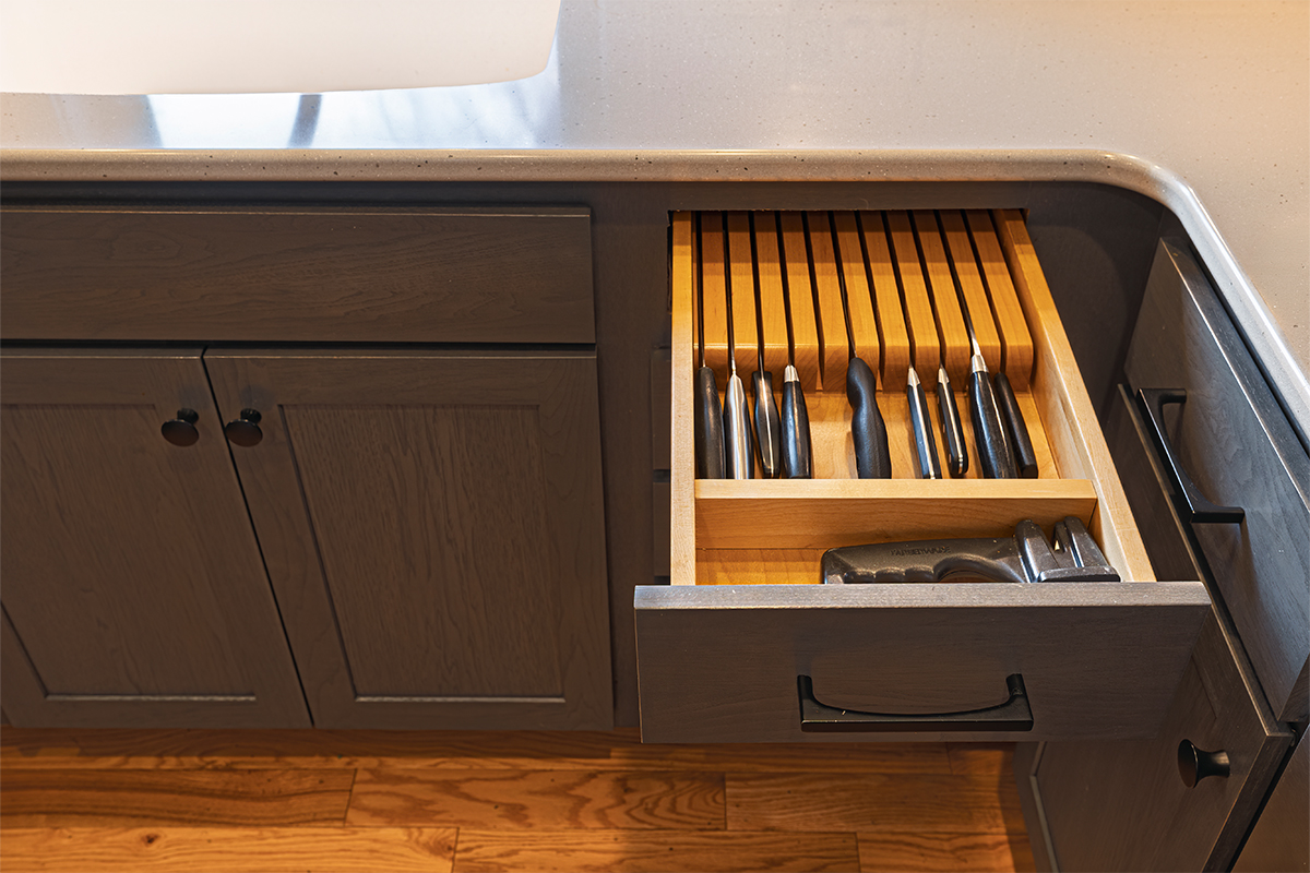 Base cabinet with drawer pulled out showing a knife organizer