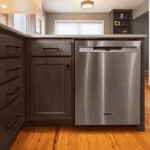 Gray stained cabinets with stainless steel dishwasher