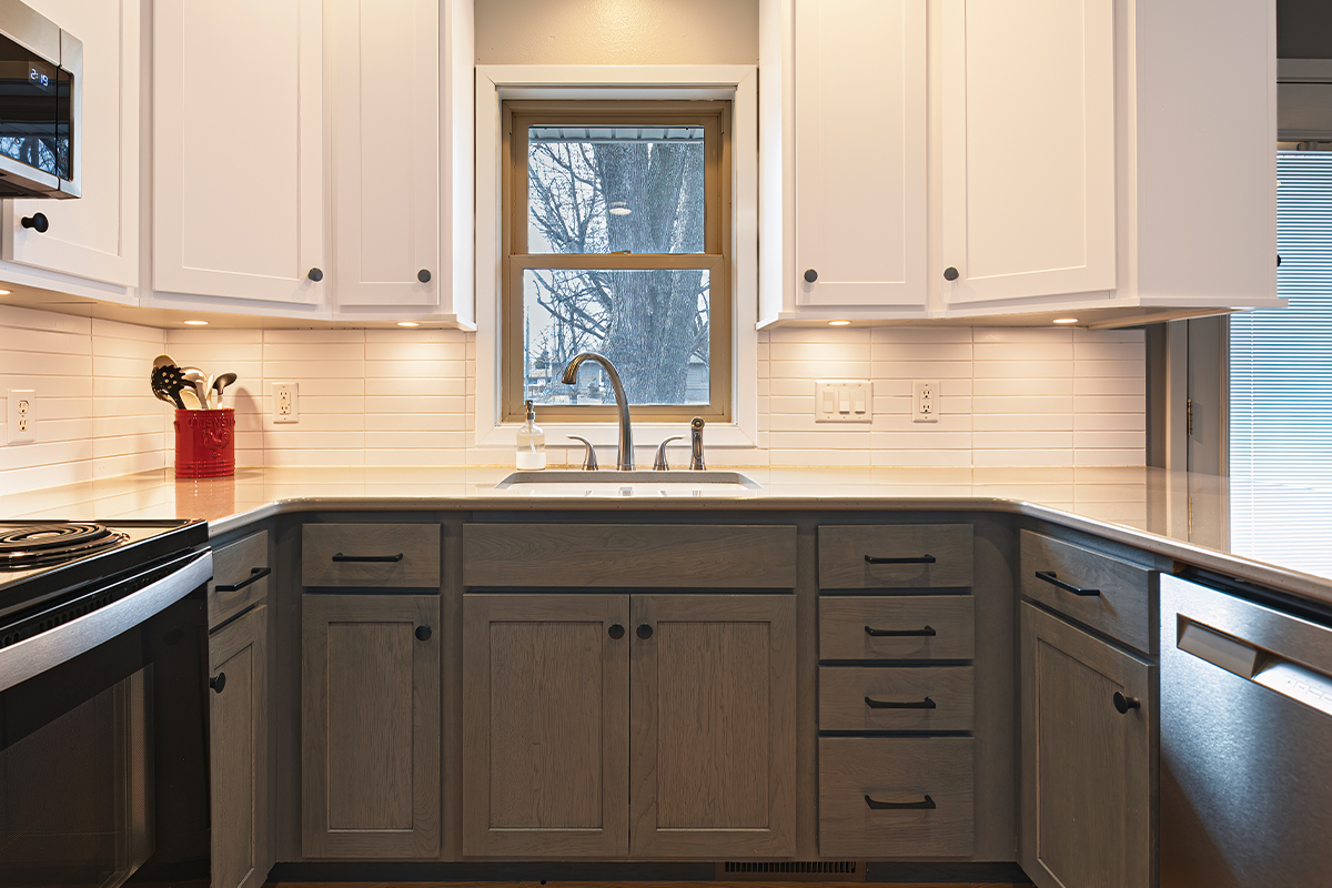 White uppers and gray stained lower kitchen cabinets