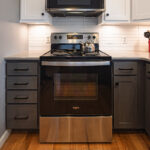 White uppers and gray stained lower kitchen cabinets