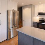 White uppers and gray stained lower kitchen cabinets