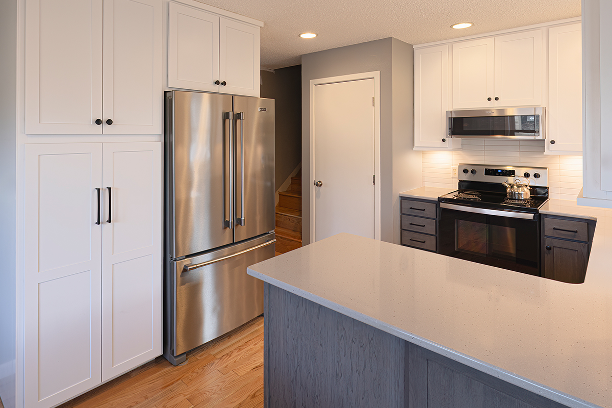 White uppers and gray stained lower kitchen cabinets