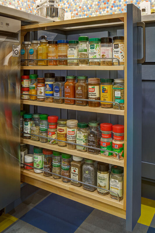 Blue kitchen cabinet with spice pullout