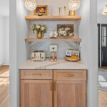 Brown stained bar cabinets with floating shelves.