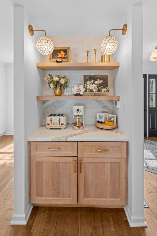 Brown stained bar cabinets with floating shelves.