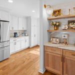 Brown stained bar cabinets with floating shelves.