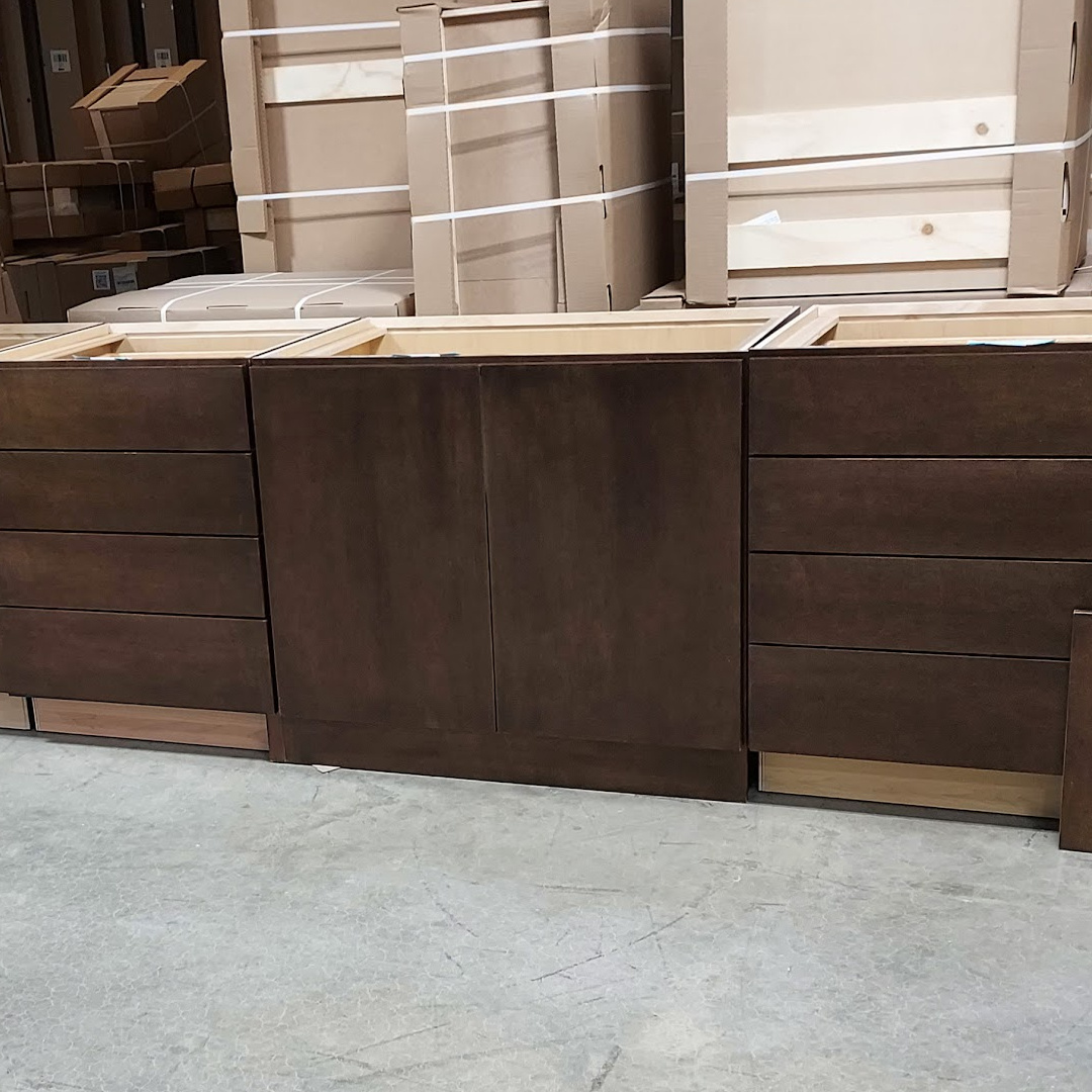 Drawer bases and base with full height doors in a warehouse setting. Finished in a rich brown/red Kona stain.