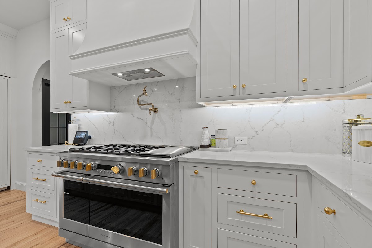 White kitchen perimeter cabinets with stainless steel stove