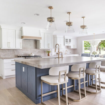 Kitchen with white perimeter and blue island cabinets.