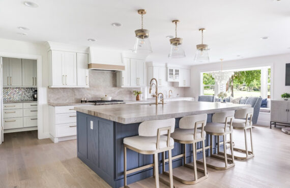 Kitchen with white perimeter and blue island cabinets.