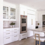 Kitchen with white perimeter and blue island cabinets.