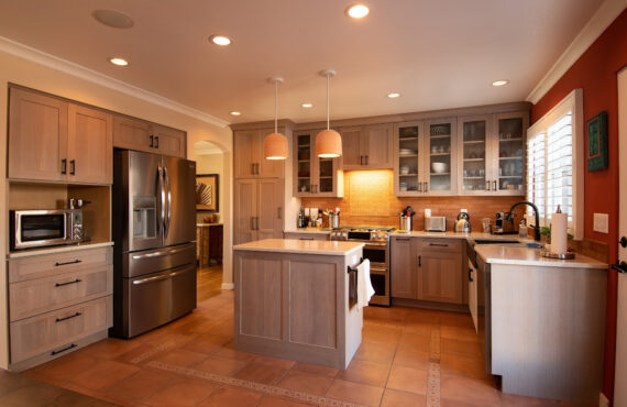 Quartersawn White Oak kitchen in a light Pampas finish with small island and stainless steel appliances.