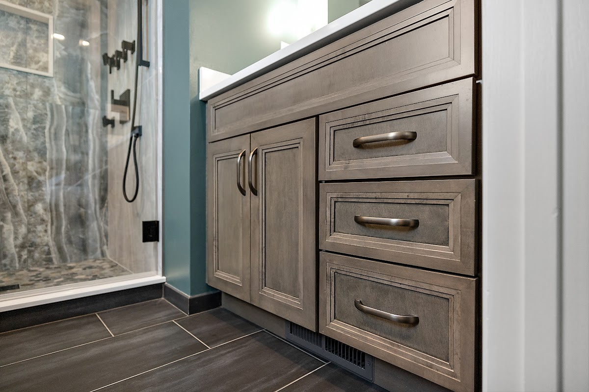 Brown stained bathroom vanity next to a glass steam shower.