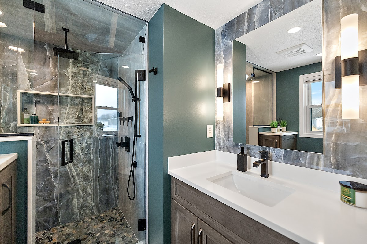 Brown stained bathroom vanity next to a glass steam shower.
