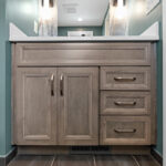 Brown stained bathroom vanity next to a glass steam shower.