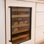 White wine cooler door covering a under counter wine cooler.