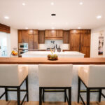 Walnut kitchen cabinets with white double islands