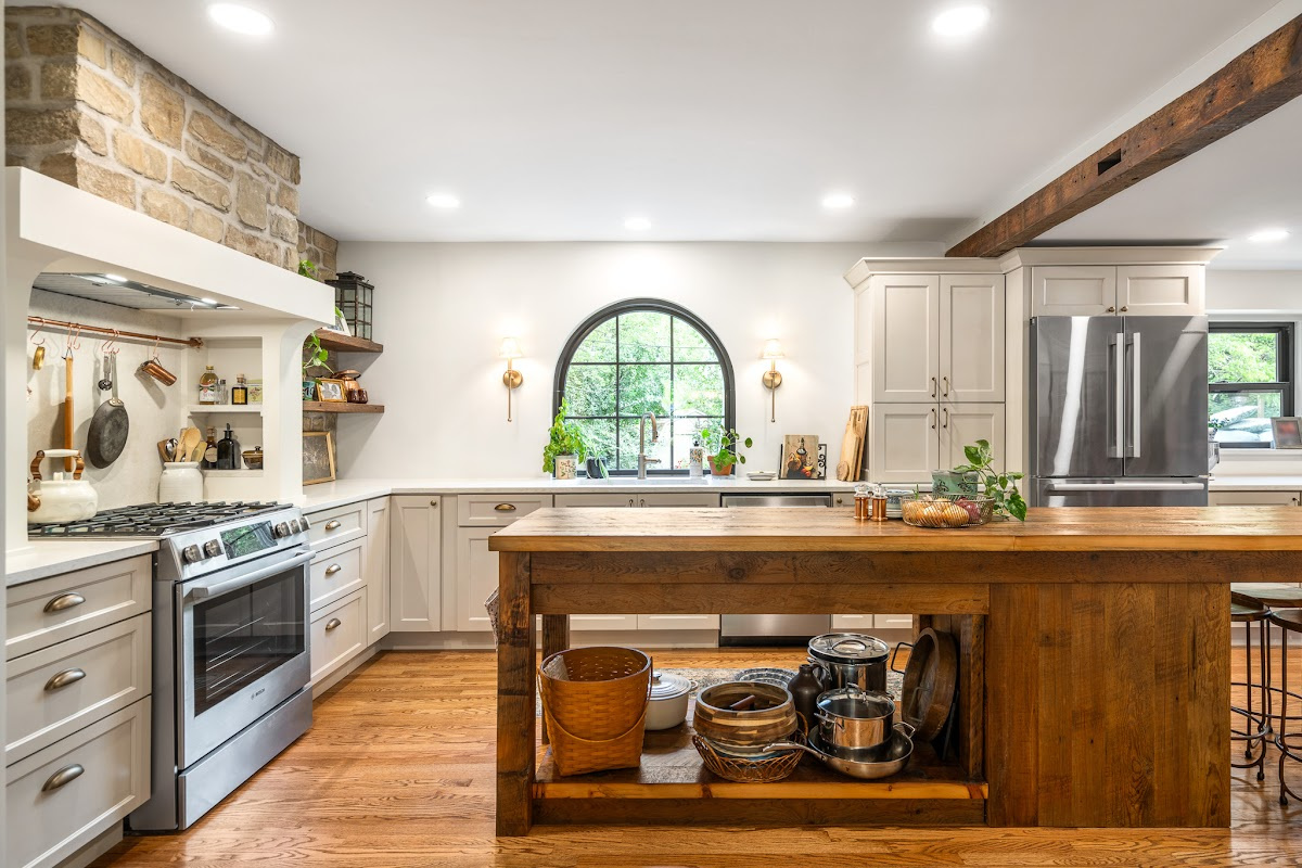 Old World style kitchen with Light Mocha-painted perimeter and a custom wood island in a mid-brown stain.