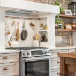 Old World style kitchen with Light Mocha-painted perimeter and a custom wood island in a mid-brown stain.