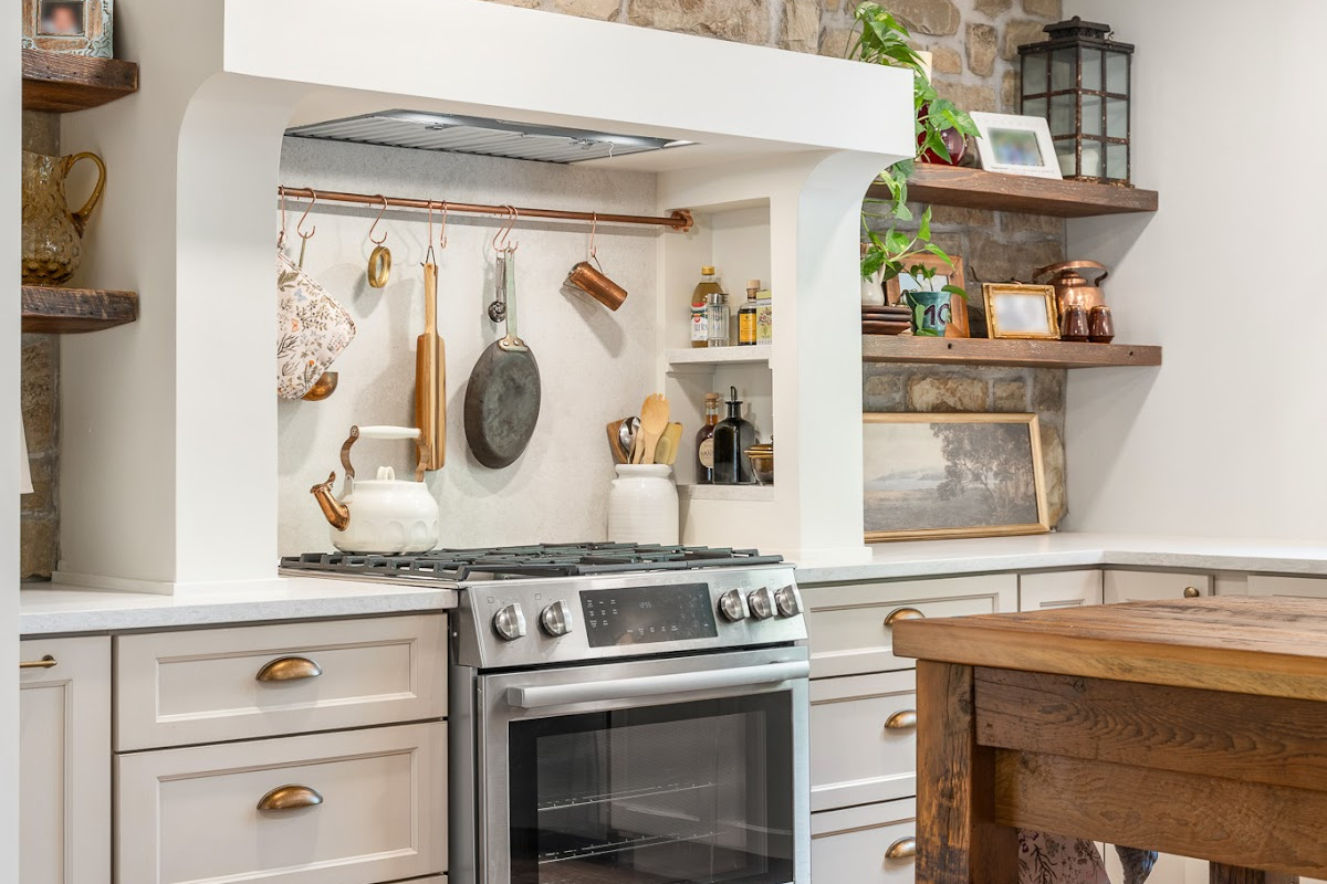 Old World style kitchen with Light Mocha-painted perimeter and a custom wood island in a mid-brown stain.