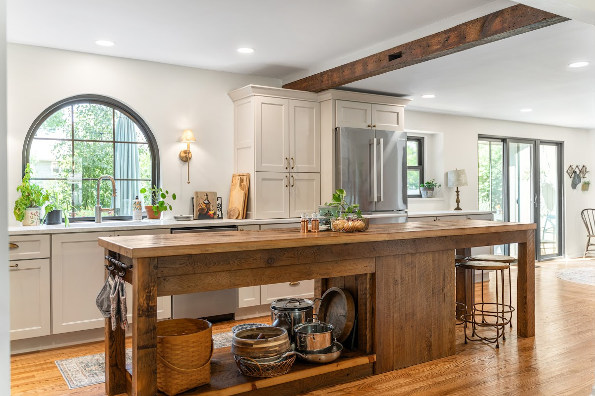 Old World style kitchen with Light Mocha-painted perimeter and a custom wood island in a mid-brown stain.