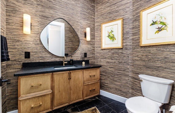 Bathroom with warm, organic tones, including a brown-stained vanity cabinet.