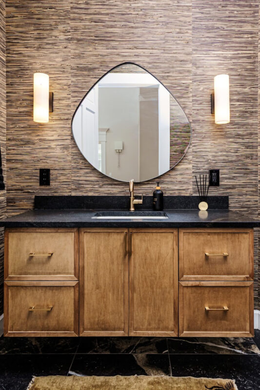 Bathroom with warm, organic tones, including a brown-stained vanity cabinet.