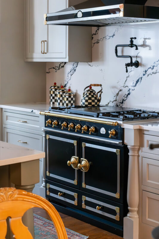 Painted gray kitchen cabinets with black range